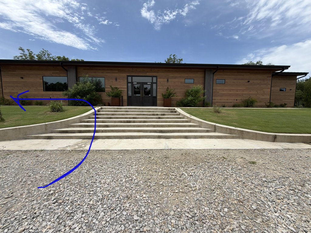 Venue entrance from the parking lot with an arrow pointing left to the groom's suite